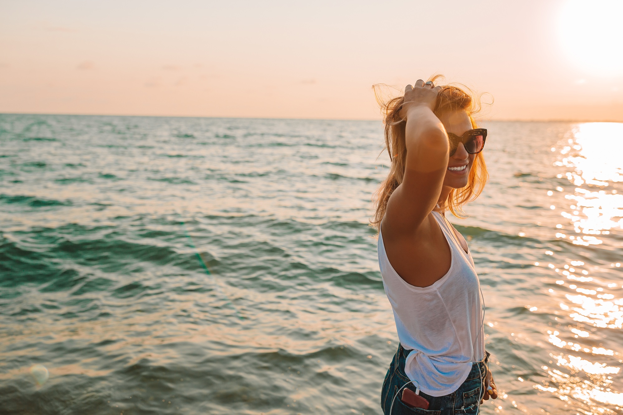 Outdoor fashion portrait of stylish woman on the beach